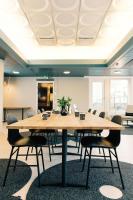 a conference room with a large wooden table and chairs at Hotel Sparre in Porvoo