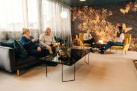 a group of people sitting in a living room at Hotel Sparre in Porvoo