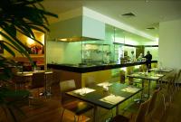 a restaurant with tables and chairs and a counter at The Jerai Hotel Alor Star in Alor Setar