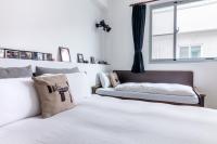 a bedroom with two beds and a window at Ciao Life B&amp;B in Taitung City