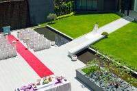 a wedding ceremony in a garden with a red carpet at Platinum Hotel in Xindian