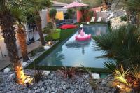 a backyard pool with a pink flamingo in the water at Maison entre bordeaux et le bassin d&#39;arcachon avec piscine et jaccuzi 2 a 6 pers in Saint-Jean-dʼIllac
