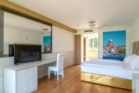 a bedroom with a large bed and a tv at Hotel Sveti Kriz in Trogir