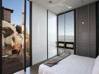 a bedroom with a bed and a large window at Encuentro Guadalupe in Valle de Guadalupe