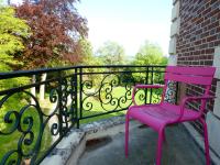 a pink chair sitting on a railing on a balcony at Chateau de Hiéville in Hiéville