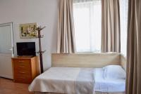 A bed or beds in a room at Family Hotel Apolonia