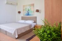 A bed or beds in a room at Family Hotel Apolonia