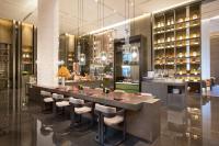 um restaurante com um bar com bancos num quarto em InterContinental Xi'an Hi-Tech Zone em Xian