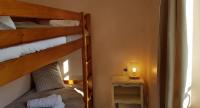 a small room with two bunk beds and a table at Hôtel Terminus in Luz-Saint-Sauveur