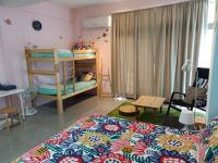 a bedroom with a bed and a bunk bed at Fish Hostel in Yingge