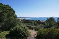 a view of the ocean from a hill with trees at Bel Appartement accès direct mer; L&#39;Almanarre, HYERES in Hyères