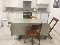 a kitchen with a white table and two chairs at Le bord de Loire in Basse-Indre