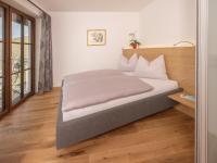 A bed or beds in a room at Brunnwirt ESSEN & WOHNEN