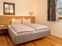 A bed or beds in a room at Brunnwirt ESSEN & WOHNEN