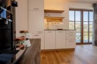 A kitchen or kitchenette at Brunnwirt ESSEN & WOHNEN
