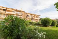 an apartment building with a garden in front of it at Résidence Pierre &amp; Vacances Eden Parc in Saint-Tropez