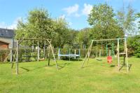 a playground with two swings in a yard at Maison confortable séjour spacieux, belle terrasse avec grand jardin avec jeux extérieurs près Bayeux et Omaha Beach in Saonnet