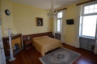 a bedroom with a bed and a tv and a window at Hotel Villa Ruscello in Baveno