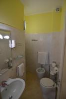 a bathroom with a white toilet and a sink at Hotel Villa Ruscello in Baveno