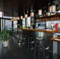 a bar in a restaurant with stools at citizenM New York Times Square in New York