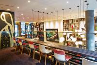 a bar with red and white chairs in a restaurant at citizenM New York Times Square in New York