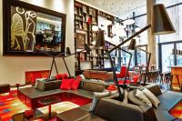 a living room with couches and a bar at citizenM New York Times Square in New York
