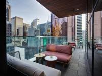 a balcony with a couch and tables on a building at citizenM New York Times Square in New York