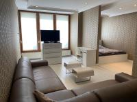 a living room with a couch and a television at Ruben Apartman City Center in Debrecen