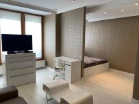 a room with a tv and a desk and a bed at Ruben Apartman City Center in Debrecen
