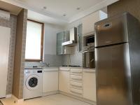 a kitchen with a stainless steel refrigerator and a dishwasher at Ruben Apartman City Center in Debrecen