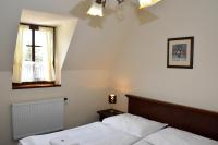 Postel nebo postele na pokoji v ubytování Hotel Buchlovice