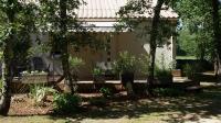 a house with chairs and trees in the yard at Clos l&#39;Oustal in Labastide-de-Virac