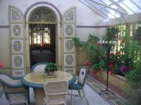 a room with a table and chairs and flowers at Chambres d&#39;hôtes Manoir Ker-Huella in Morlaix