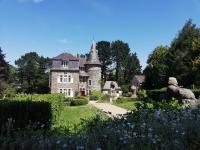 an old castle in the middle of a garden at Chambres d&#39;hôtes Manoir Ker-Huella in Morlaix