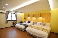 a hotel room with two beds and a window at No. 21 Jiaoxi Hot Spring Homestay in Jiaoxi