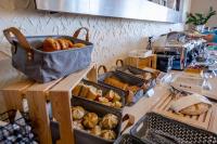 eine Bäckerei mit mehreren Tabletts mit Brot und Gebäck auf einer Theke in der Unterkunft Park Hotel Diament Katowice in Kattowitz