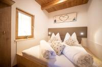 Een bed of bedden in een kamer bij Weingarten &amp; Appartement Auszeit - Therme Loipersdorf