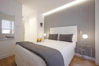 Postel nebo postele na pokoji v ubytování Gran Via Suites