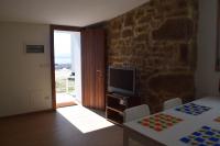 A television and/or entertainment centre at Pedra da Lan - una casita de piedra