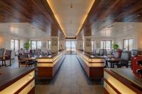 a restaurant with tables and chairs in a room at The Promenade in Puducherry