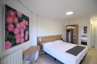 A bed or beds in a room at Apartamentos Gran Socaire de Noja