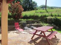 four chairs and a picnic table on a patio at GITE IBARLA BORDA in Bidarray