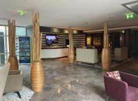 a lobby with chairs and a bar with a tv at SL&#39;otel im Parforcehaus in Bernburg