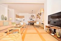 A television and/or entertainment centre at 70sqm private terrace in front of the sea & 107sqm brand new apartment