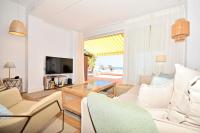 A television and/or entertainment centre at 70sqm private terrace in front of the sea & 107sqm brand new apartment