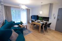 Televízia a/alebo spoločenská miestnosť v ubytovaní Słoneczne Tarasy II - Apartments