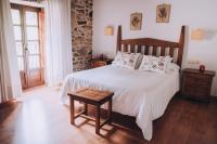 Postel nebo postele na pokoji v ubytování Casa de Santa Uxía