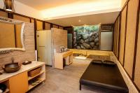 a bathroom with a large tub and a sink at Fuli Hot Spring Resort in Yuchi