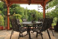 a table and chairs on a patio with a view of the trees at Buchschneider - Ferienhaus Maier - Landhof in Schwarzautal