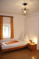 a bedroom with a bed with a window and a light at Buchschneider - Ferienhaus Maier - Landhof in Schwarzautal